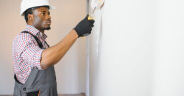young male electrician install electrical outlets and switch