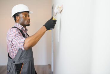 young male electrician install electrical outlets and switch